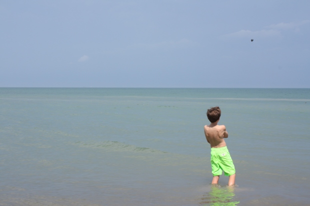 My cousin Jack apparent had enough with skipping rocks into Lake Huron and decided to simply throw this rock instead. (Photo by Erin Klema)